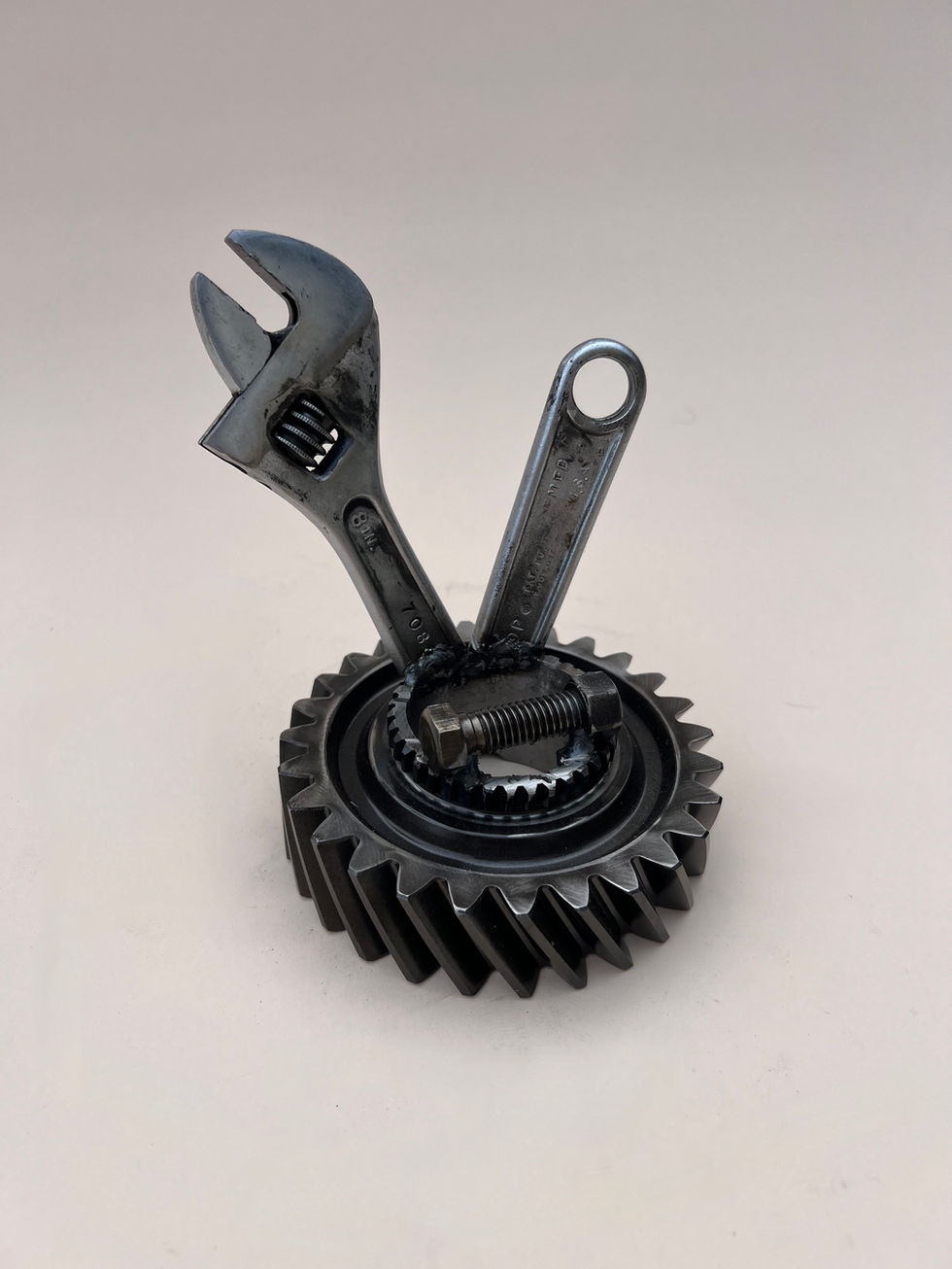 Metal phone or card holder made from a gear and an adjustable wrench
