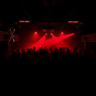 nightclub, red LEDs, people dancing, dark setting, main tone black.jpg