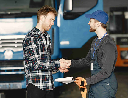 two-guys-talking-about-work-work-garage-near-truck-transfer-documents-with-goods-compresse