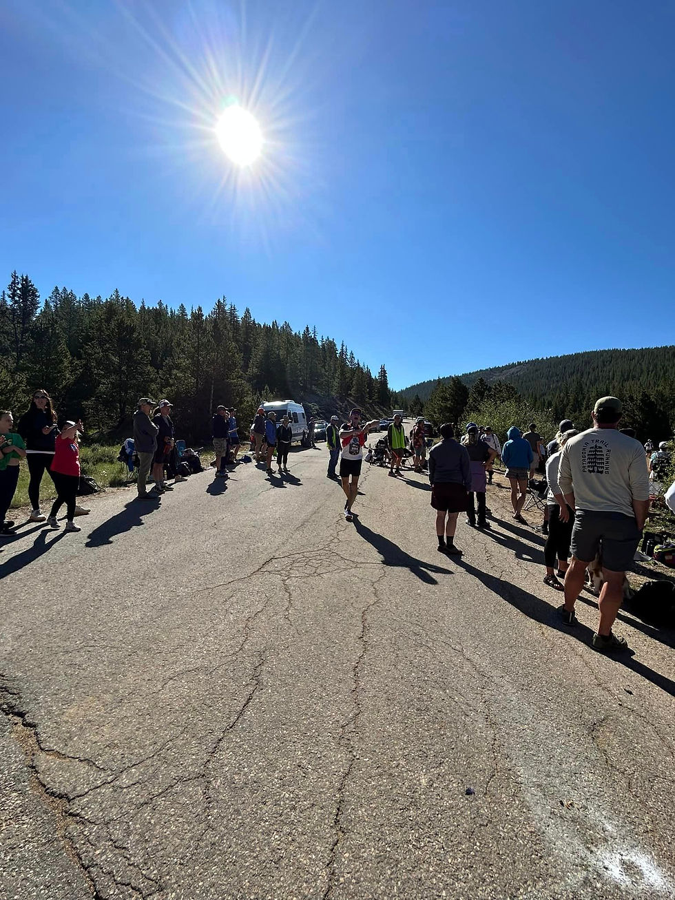 Paved road filled with runners and their crew members.
