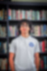 Male student standing in front of a bookcase