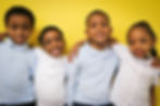 St. Ailbe Students in front of a yellow wall