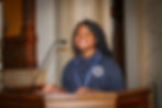 Female student speaking at a podium