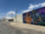 Professional graffiti removal from a commercial building exterior, restoring the surface to its original clean finish using specialized pressure washing and paint matching. For urgent restoration services, call Solano Property Maintenance at 626-344-0337