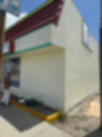 Professional graffiti removal from a commercial building exterior, restoring the surface to its original clean finish using specialized pressure washing and paint matching. For urgent restoration services, call Solano Property Maintenance at 626-344-0337