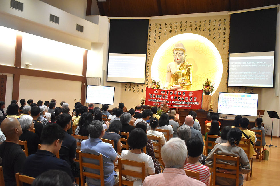 Nearly 140 devotees and community members fill the venue, with simultaneous English interpretation provided throughout the event.