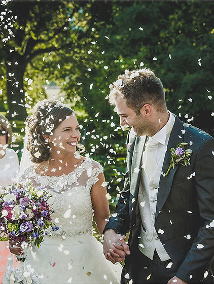 A newly married couple showered with confetti