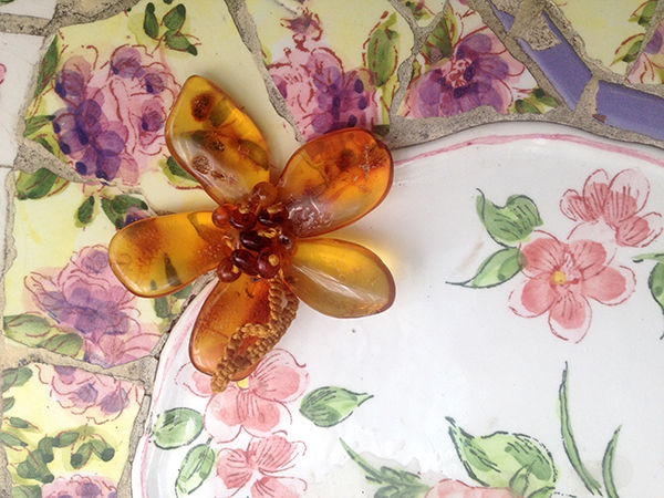 Close-up view of a gift box with amber jewelry and a gift card inside