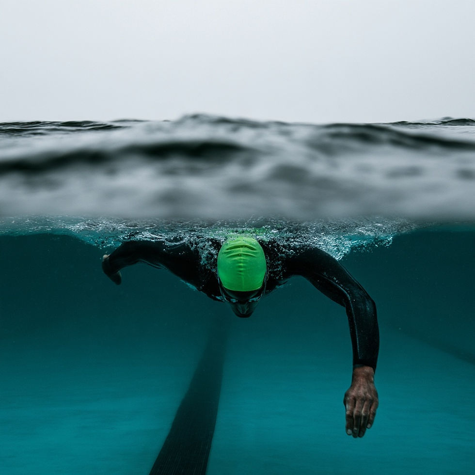 A swimmer partially in the open water and partially in a pool