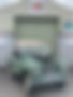 Green Land Rover parked near a garage with sign, Wantage 4X4 ABOUT vehicle.