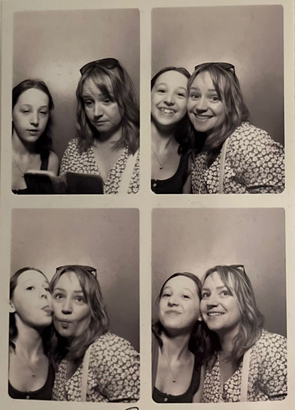 black and white passport booth group of four photos shwoing woman and teenage girl pulling funny faces