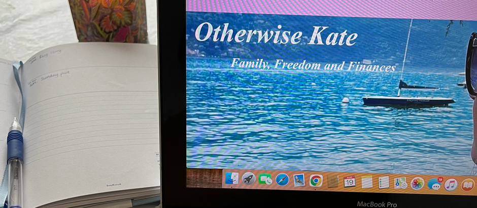Laptop screen shows a blog titled "Otherwise Kate" with a scenic lake view. A woman in sunglasses overlooks the water. Keyboard visible below.