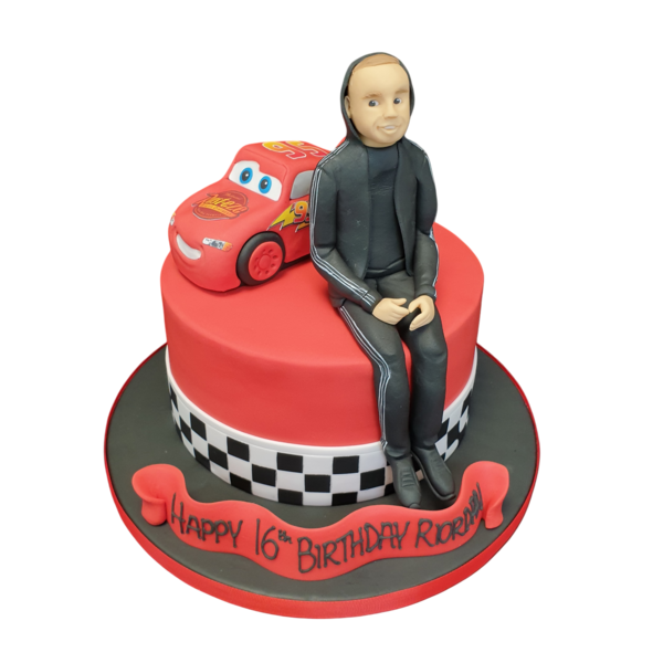 A vibrant and intricately decorated car-themed celebration cake for a birthday party, featuring 3D fondant car figurines on top of a smooth white icing base. Ideal for car enthusiasts.