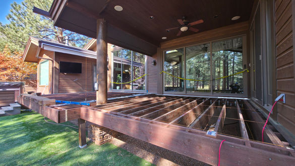 Deck teardown in progress in Flagstaff with old boards removed and structure exposed for rebuild