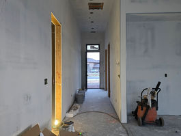 Interior entry with patched walls and work materials during drywall repair