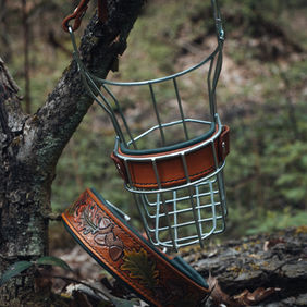 Passendes Set aus punziertem Lederhalsband und Maulkorb im Wald-Design