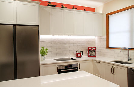 White kitchen with subway tiles and shaker panels