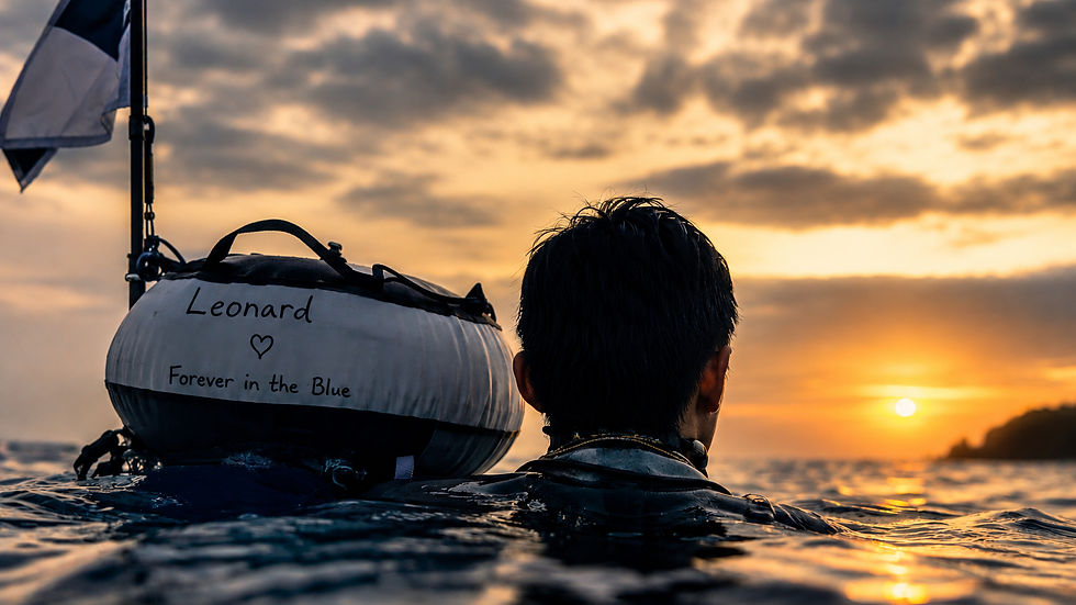 Person swimming in ocean at sunset, beside a buoy with "Leonard ♥ Forever in the Blue" written on it. Calm ambiance, warm colors.