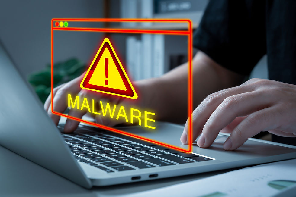 People working on laptop computer with malware attack warning graphic icon.jpg