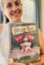 Julie holds up a copy of Bitsy Bat, School Star.