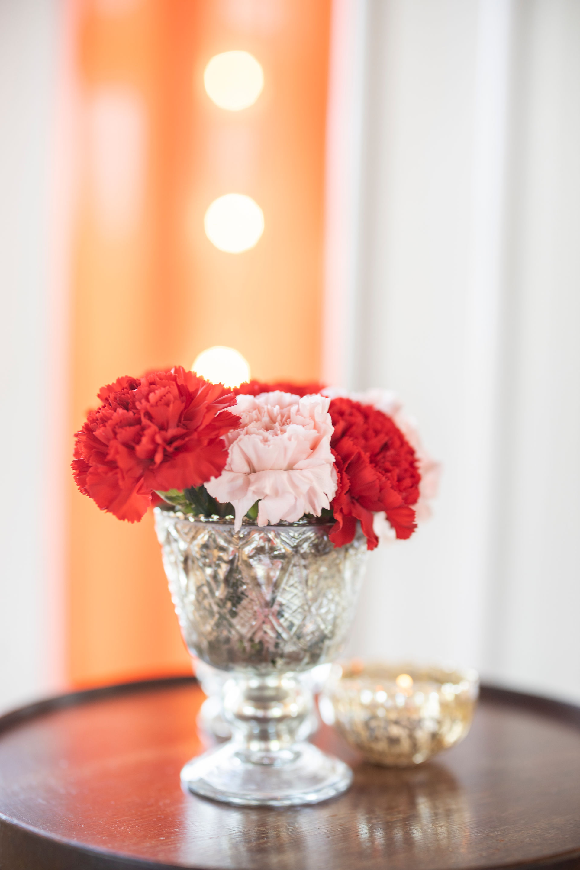 Little petite centerpieces with colorful carnations and vintage pedestal vases for Pakistani wedding in Alaska