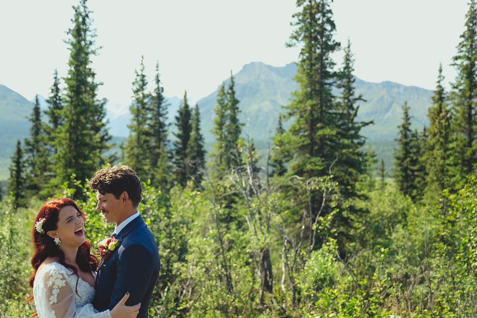 laughing bride, enjoying Alaska elopement, mountain backdrop