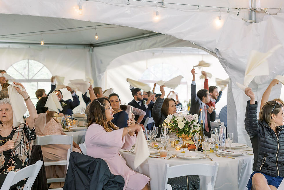 Wedding reception, guests swinging napkins to welcome bride and groom