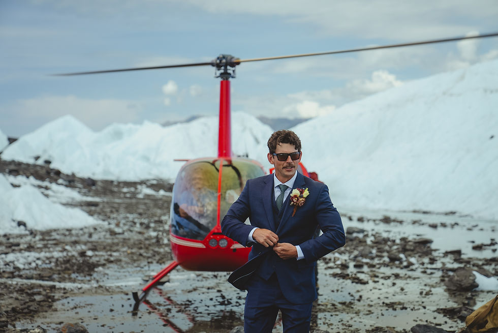 helicopter with groom for exclusive transportation to Alaska glacier for ceremony