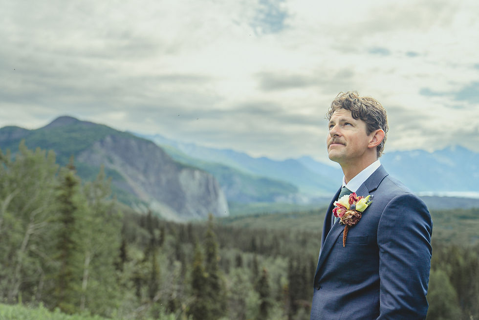 Rustic groom in Alaska with mountain background. Fully customized Alaska elopement for two.