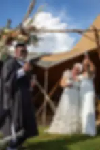 Two brides at tipi wedding ceremony