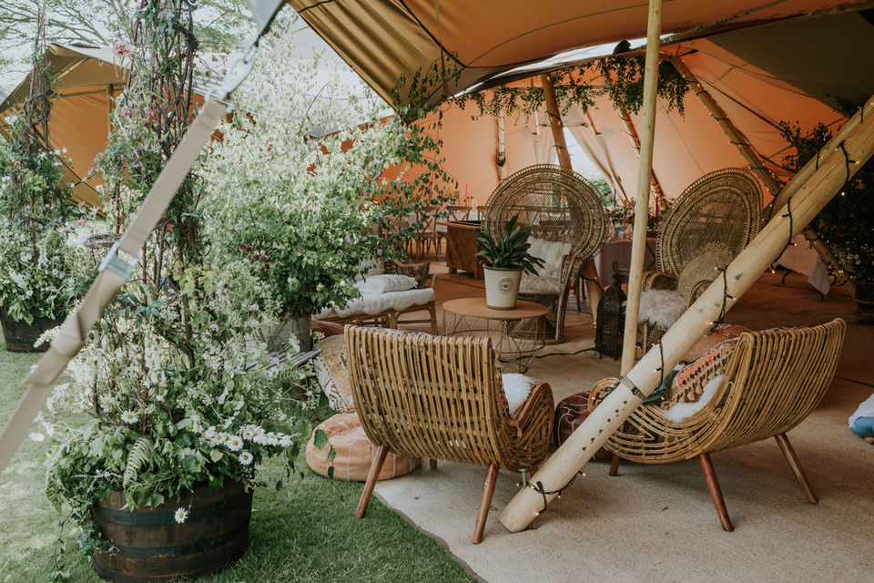 Garden tipi wedding with chill out lounge area.
