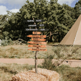 Tipi festival wedding with rustic signage