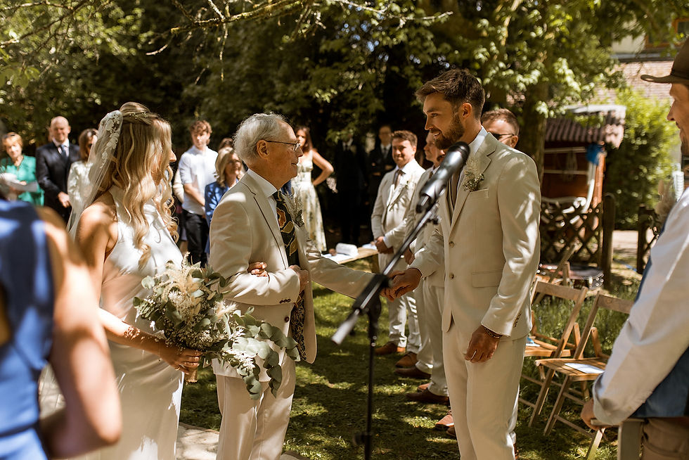 Bride, groom and father of the bride in garden wedding ceremony