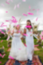 Two brides at outdoor wedding ceremony
