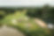 Drone image of tipi festival wedding with giant tipis and bell tents with outdoor ceremony and wedding party
