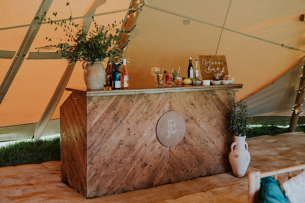 Rustic wooden bar in teepee for festival wedding