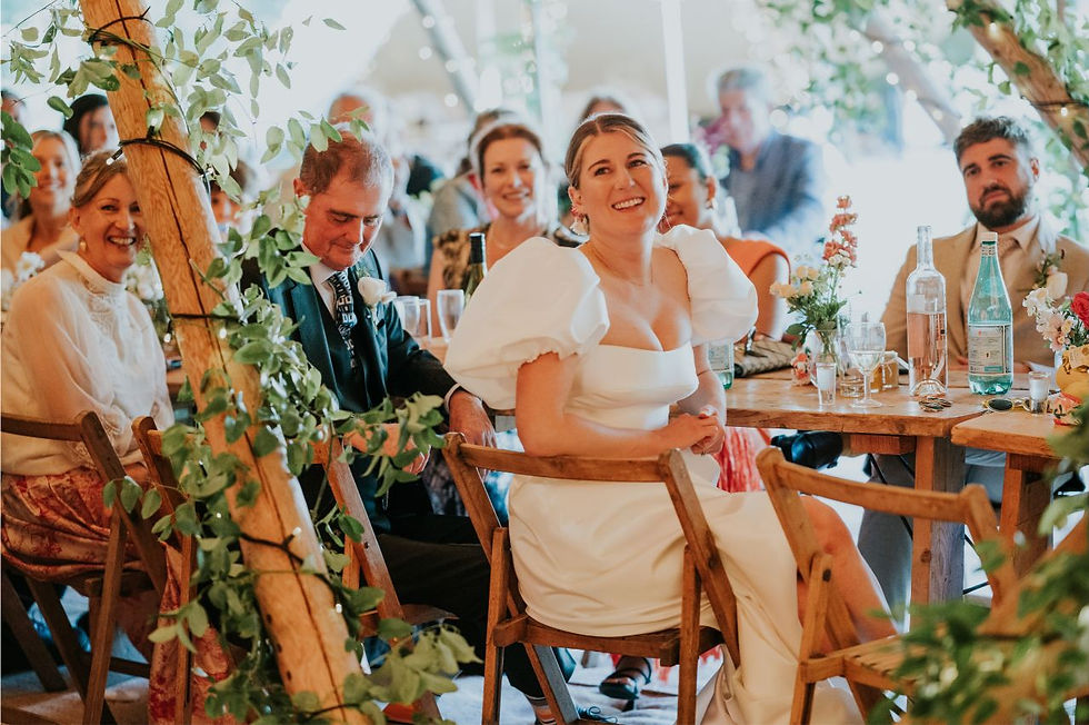 Bride sitting at table at tipi wedding