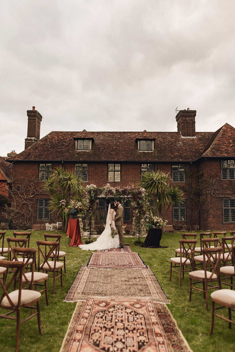 Outdoor wedding ceremony outside manor house in Sussex