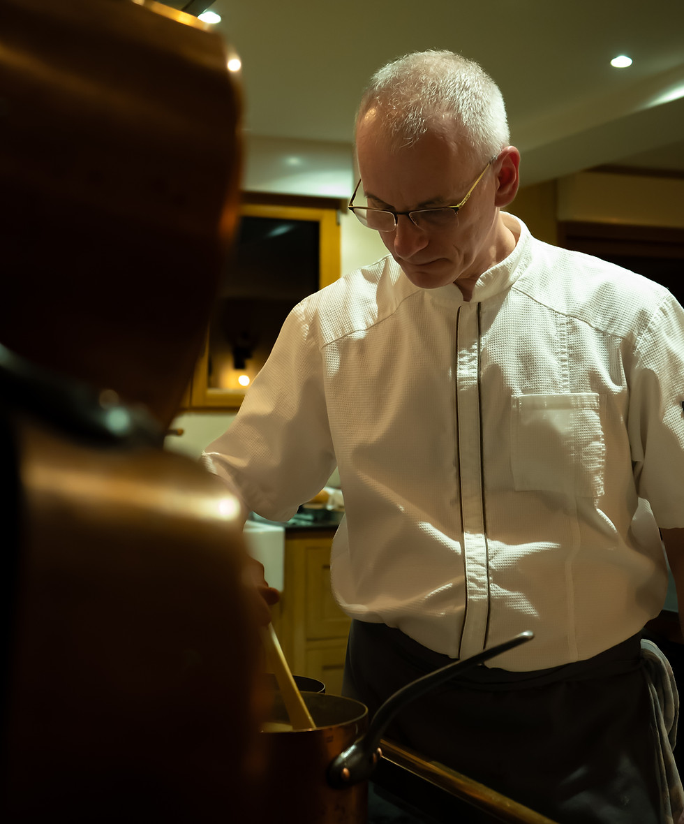 Professional French chef preparing a gourmet dish during an immersive countryside cooking retreat in France