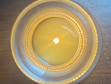 A TruSpace all-natural candle casting a soft, warm glow — a symbol of gentle presence, intentional living and the quiet beauty of creating a sacred space for oneself.