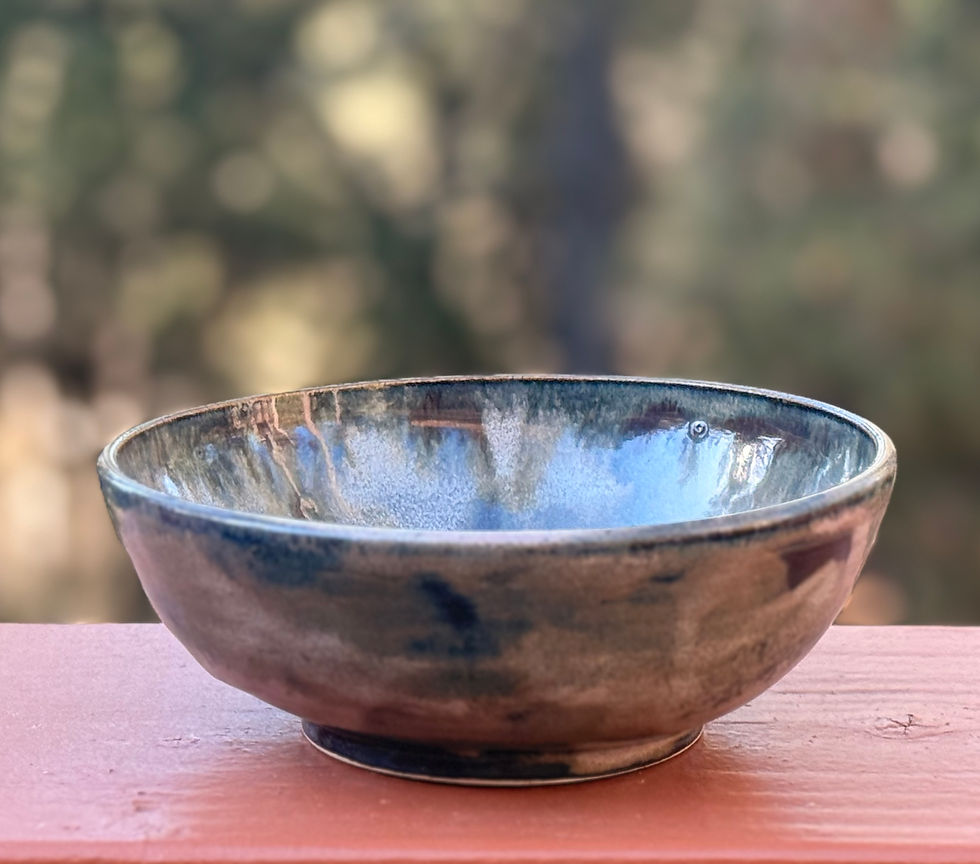 Thumbnail: Earth-toned stoneware serving bowl on a wooden railing.