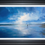 Thumbnail: Eternal Tide seascape painting by Ben Goymour framed in black, showing a peaceful beach scene, light breaking through clouds