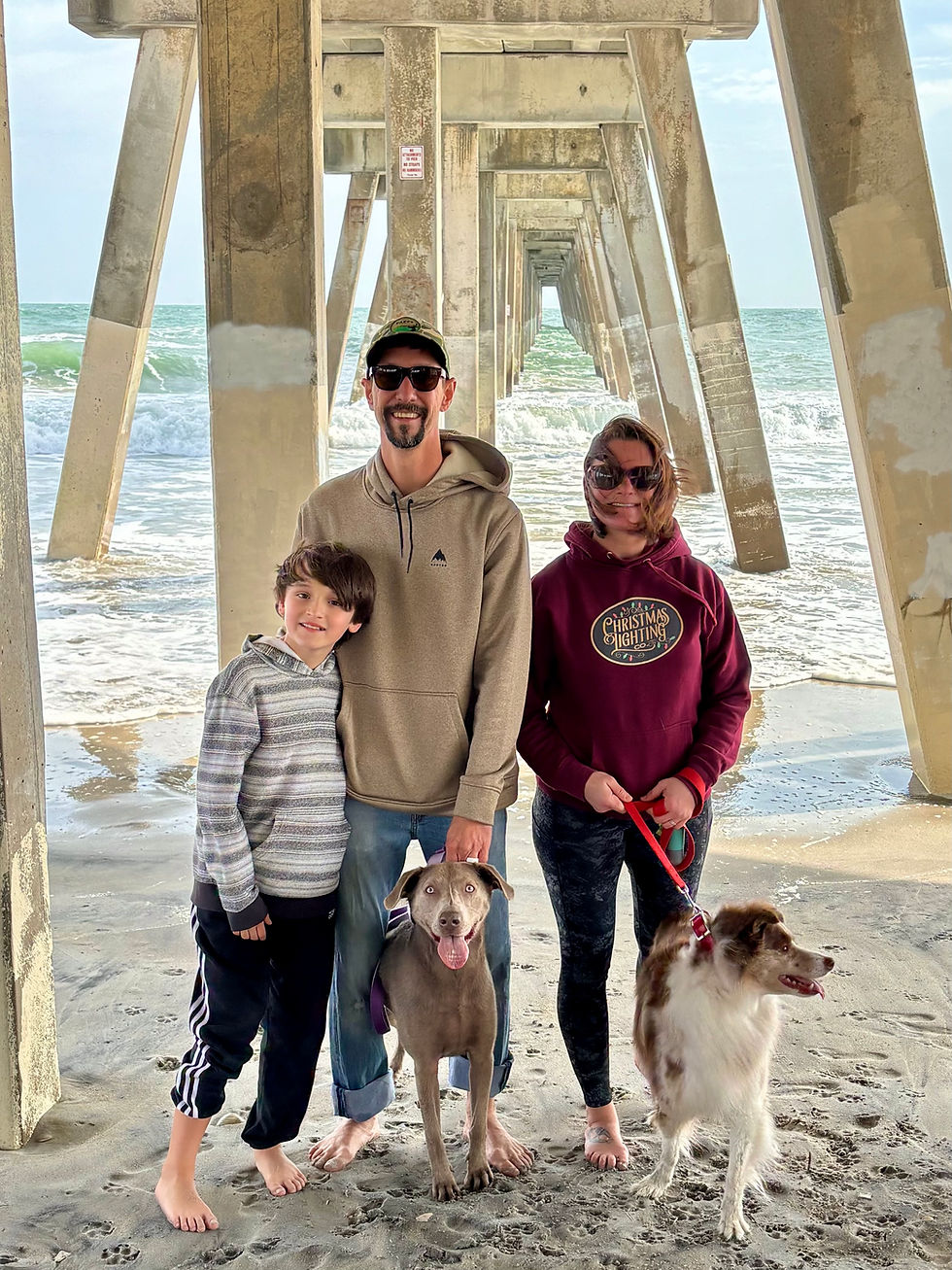 Christmas Lighting Co. founder Robert Absher with his family and dogs
