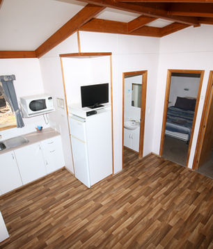 Kitchen and dining area inside a Deluxe Cabin at Corny Point Caravan Park