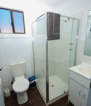 Bathroom with shower and toilet inside a Standard Cabin