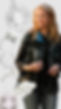 A background of Shana Farr’s jewelry designs. She is wearing a Mieko Mintz jacket with 