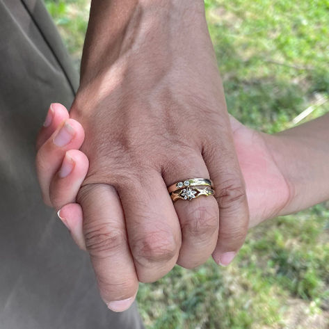 The Baby Promise Duet Ring worn with a wedding band