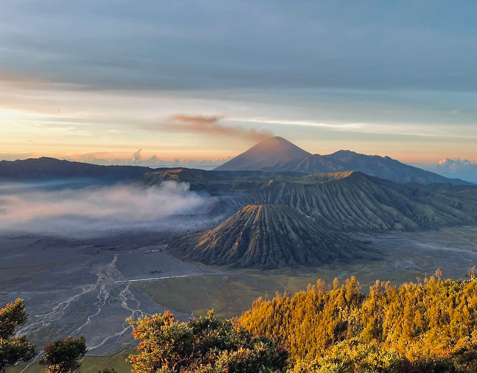 Stunning viewpoint at Mount Bromo with panoramic views of the volcano, misty caldera, and vibrant sunrise colors.