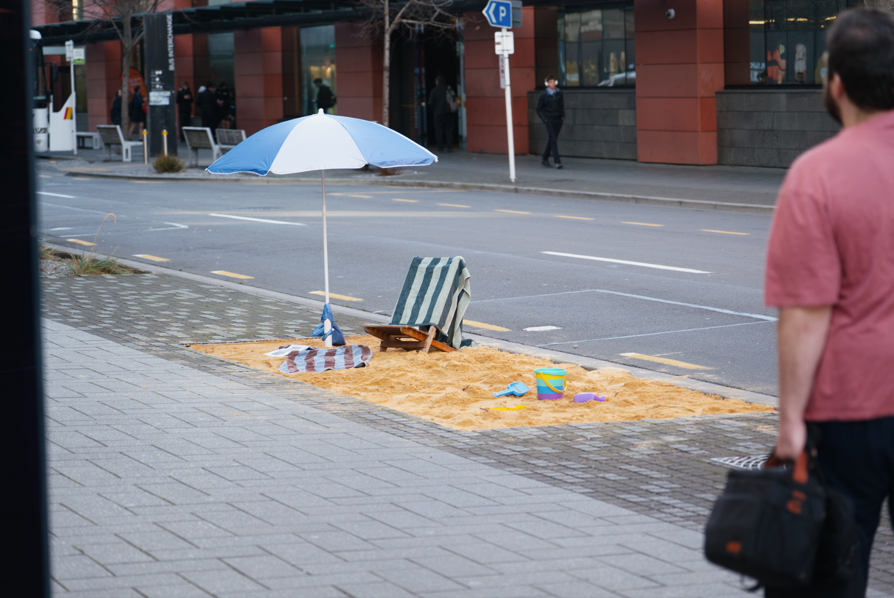 A golden sand beach installed in a gritty urban inner city by artist Cameron Hunt.