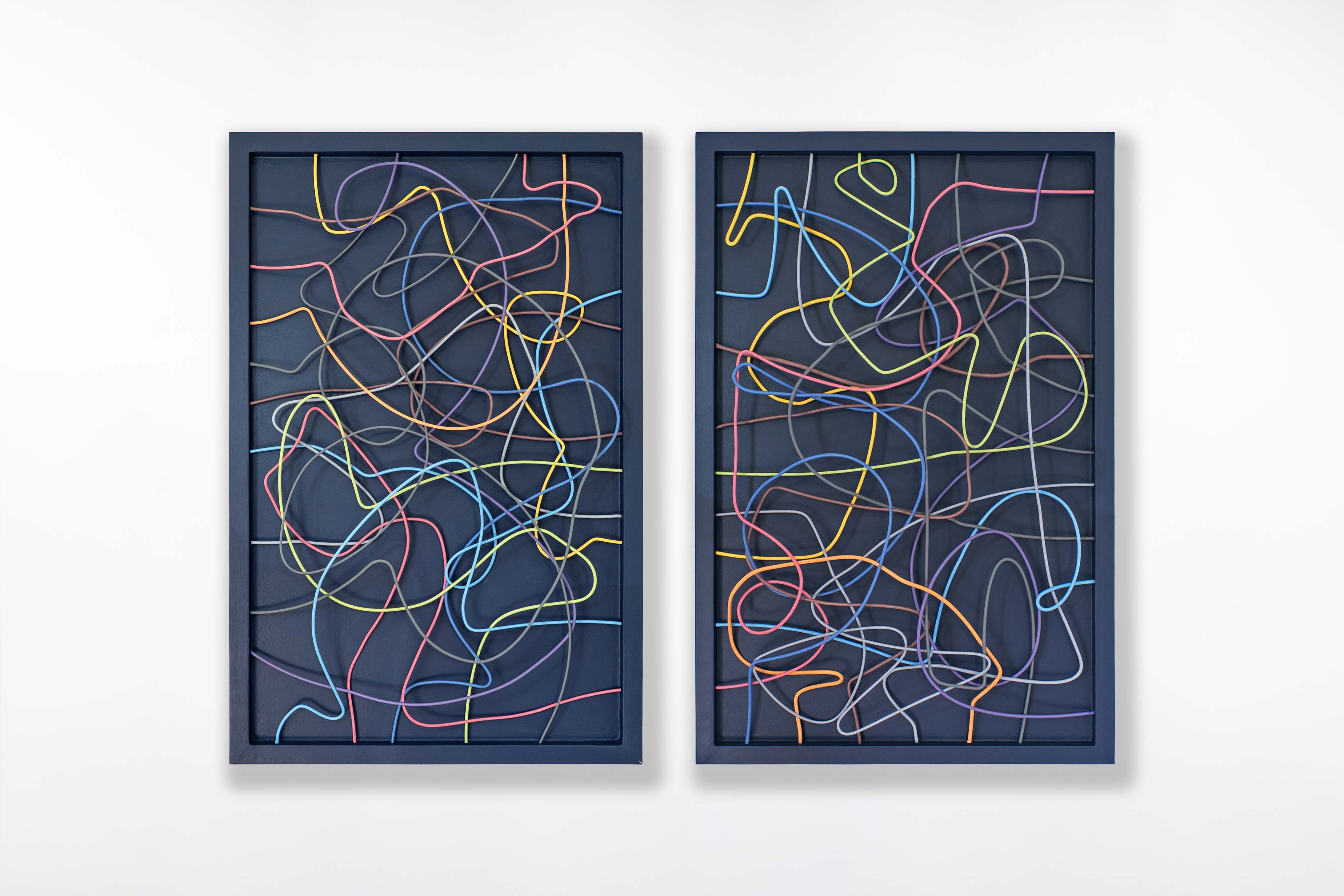 Front view of Cameron Hunt’s diptych wire sculpture, showing vivid, intertwined coloured wires against a deep blue frame.